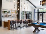 A resident lounge is centrally located with multiple seating areas, a fireplace, bar, billiards, and television viewing area.