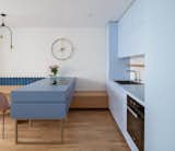 When architecture and interior design studio idea:list renovated an apartment in Slovenia's capital, Ljubljana, they opted for light, feminine finishes including a powder blue wall of cabinets that are balanced by a darker, moodier deep blue island.