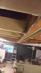 Bucket brackets holding 30 ft beam in place