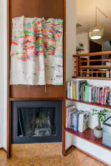 New railings and shelves harmonize with the original fireplace