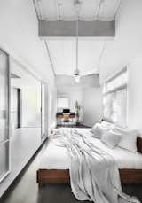The white palette brings tranquility into the master bedroom. The loftiness of the ceiling continues here, with highlighted  beams to continue the industrial aesthetic. 