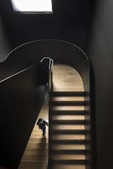 The staircase is offset from the straight walls to emphasize its curvaceous lines. 