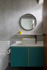 The principal bathroom features the same green tone found in the principal bedroom and wardrobe.