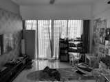 Before: The living room featured gaudy wallpaper and glossy floor tiles