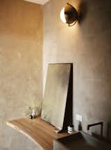 In the guest bathroom, a light scone from West Elm hangs on lime-washed walls.