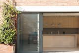 A sliding door opens up the kitchen.  Photo 18 of 27 in Before & After: An L.A. Loft in a Former Nabisco Factory Gets a Japanese-Inspired Makeover