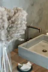 Like the rest of the house, the guest bathroom mixes industrial elements with tactile, Japanese-inspired touches.