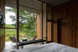 An asymmetrical window curates the view from the principal bedroom. 