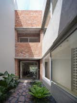 A large window separating the corridor from  the courtyard makes it a bright and airy passageway. 