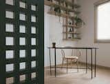 The study room is a cosy space with additional light from the screen-like windows that looks to the main living areas. 