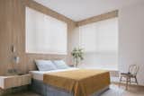Oak timber veneer cladding frames the master bedroom's sleeping corner. 