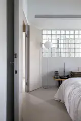 Glass blocks create a casual and connected relationship between the master bedroom and master bathroom. 
