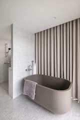 In the master bathroom, a taupe-coloured Dafne bathtub from Cielo creates a cohesive composition with the neutral colour palette.    Photo 20 of 116 in Craigs Drive by Scott B from This Renovated Taipei Apartment Sees the Glass Brick Trend All the Way Through