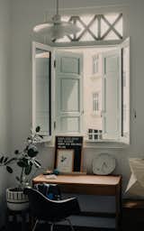 After: The older son's bedroom overlooks the streets of Joo Chiat. The white-painted palette gives the room an airy and welcoming feel.