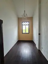 Before: The older son's bedroom with dark-painted window frames.  
