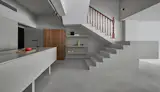 Grey colour was used to define old and new parts of the common areas on the first storey; the original timber staircase handrail was retained and highlighted as a feature.  