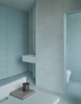 A son's bedroom with teal as the colour scheme that defines the sleeping zone from the utilitarian and storage zone. 