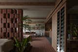 The view from the entrance into the apartment; on the left is an Inland sofa from &Tradition, chosen for its relaxed form, clean lines and subtle curves to match the bullnose bricks. 