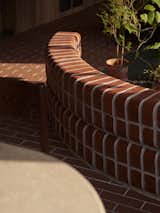 The bricks provide a semi-outdoor feel in the common spaces; most of the potted plants are placed in this part of the house as the morning sunlight is less harsh for them to grow.