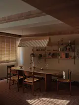 L Architects customised a long, fluted pendant lamp using watercolour paper above the dining table, which was manufactured by Superstructure, a design-to-fabrication consultancy in Singapore.   