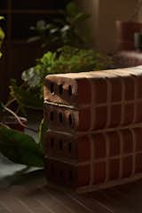 The bullnose bricks' rounded edges help soften the aesthetics of the interior; the bench pictured is a multifunctional structure - used as a divider and a bench. 