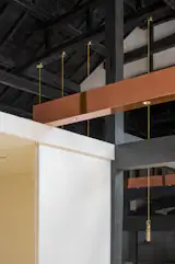 A matrix of copper beams were added hide lighting features. 