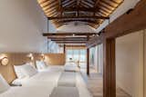 A second level was removed so the house now features the tall ceiling that was common of the igura-zukuri style house type; featured is the bedroom in the main house. 
