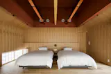 The guesthouse's largest bedroom with a five-metre-tall ceiling wrapped in washi paper. 