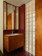 At the master bathroom, the existing white joinery was replaced  with solid Birch plywood joinery, bringing warmth and intentionality to the space. Glass blocks were used as a divider between the vanity and shower. “This not only reinforces the design language, but also allows more light into the shower area, enhancing the sense of openness and comfort,” says Jun. 