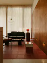 Jun lined the wall from the entrance door to the living area with solid Birch plywood panels for a sense of scale and warmth. “To maximise flexibility in a limited space, we designed a communal-style living area, intentionally omitting a television,” he says.  