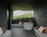 At the floor outside the children’s bedrooms, Tay designed a coffee table-sized circular void in the floor slab with a glass top that connects these two levels visually and acoustically.