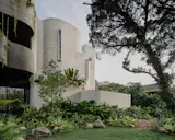 The off-form concrete corner that was left unpainted contains the staircase. 