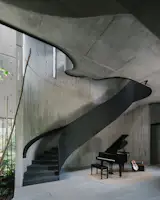 The stair core is juxtaposes expressive fluid lines and raw, robust concrete. 