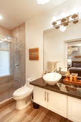 Bath Room, Recessed Lighting, Ceramic Tile Floor, Pendant Lighting, Granite Counter, Vessel Sink, One Piece Toilet, Wall Lighting, Enclosed Shower, and Ceramic Tile Wall Twin Bedroom Ensuite With Dual Sinks  Photo 14 of 16 in Casa La Jolla - A Gem With Endless Sunsets by Mike Hendry