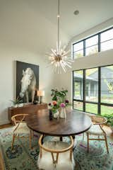 Dining room - lighting by Arteriors, table from Alder & Tweed, chairs by Dovetail, Art from Wendover Art, vintage sideboard, rug by FJ Kashanian.