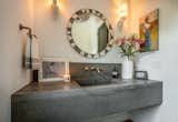 Custom cement sink in powder bath. Fixtures from Brizo, sconces from Chairish, mirror from CB2