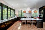 Light and airy kitchen brings the outdoors in. Windows by Kolbe, Custom cabinets by Rolling Hills Millwork, Leathered Carrara countertops, Brizo faucets, 5" white oak floors finished with Woca oil in natural - designed by Jacqueline Wheeler