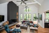 Soaring ceilings, and tons of natural light, make this living room dreamy. Sofa from Cococo, chair and ottoman from West Elm, coffee table and pouf brought back from Morocco. Baskets from Africa. Rug from Creative Touch rugs. Original art by Duy Huynh