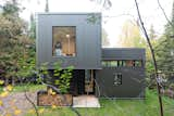 Exterior, Metal Siding Material, Cabin Building Type, Wood Siding Material, and Flat RoofLine Emily looks or the window from her seemingly floating bedroom with a tree house view.  Photo 3 of 11 in Corrugated by Satya Kommini from Jewel Box Cabin