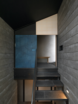 At the top of the stairs is a door covered with indigo-dyed paper.  The door slides to one side to reveal a koshikake machiai, the waiting area for guests at Japanese tea gatherings.  