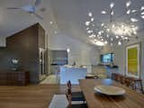 The kitchen is clean and minimal using polished white and grey cabinetry and features a wood veneered wine pantry.