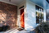 The red door creates a pop of color on an otherwise black and white slate. 