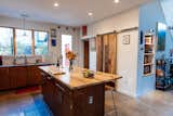 The kitchen features a large walk-in pantry and custom wood island. 