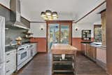Soapstone counters, custom butcher block island, dual ovens and a deep, large copper sink are some of the features of this chef's kitchen.