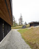 Exterior, Cabin Building Type, Shed RoofLine, Metal Roof Material, and Wood Siding Material View along entry side  Photo 8 of 17 in Meyers Residence by W  O  V  E  N   Architecture and Design