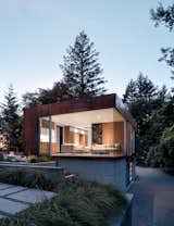 Corner Exterior Window Dusk, View of Interior Kitchenette, Living Area, Art Door