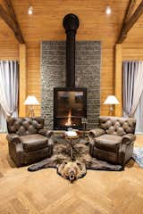 Living Room, Medium Hardwood Floor, Wood Burning Fireplace, Ceiling Lighting, Chair, and Coffee Tables  Photo 7 of 21 in Guest House by Maxim Gayevskiy