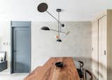 This inviting living room has a solid wood mahogany table with a lighting fixture which is a great conversation starter. 