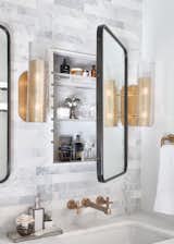 We took Rejuvenation wall mirrors and added hinges to open to custom acrylic shelving and backed with white high gloss acrylic sheet material.