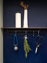 Displaying functional kitchen objects on the open steel shelving offers moments of visual interest in the otherwise muted kitchen.